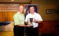 Individual Lowest Gross Winner, Greg Wallace, receives trophy from Msgr. Gregory Cox